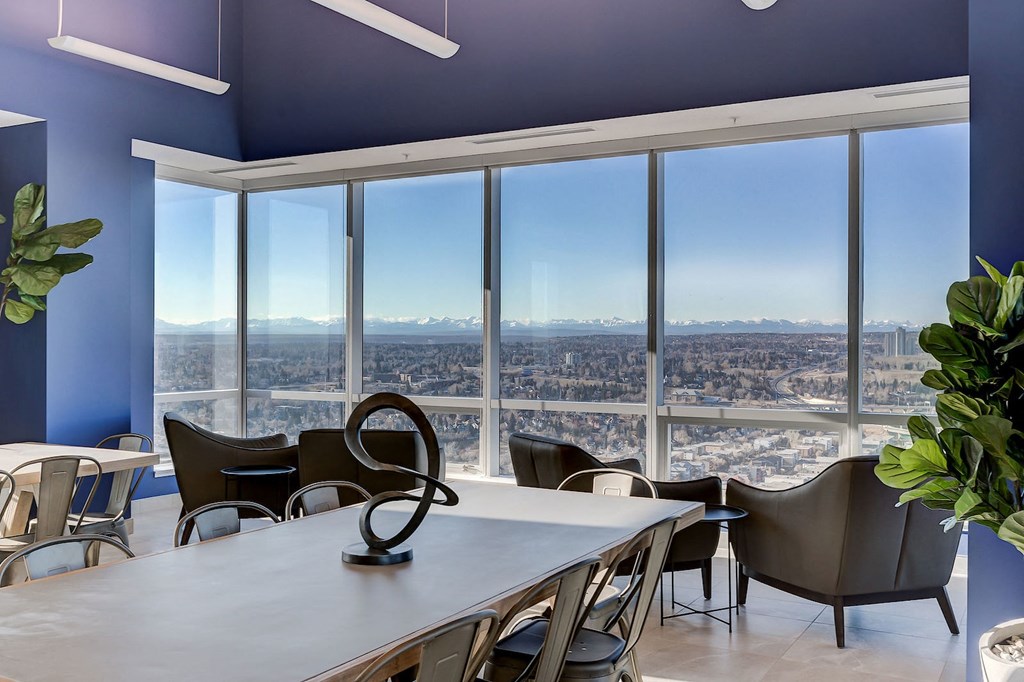 a conference room with a view of the city and a table and chairs