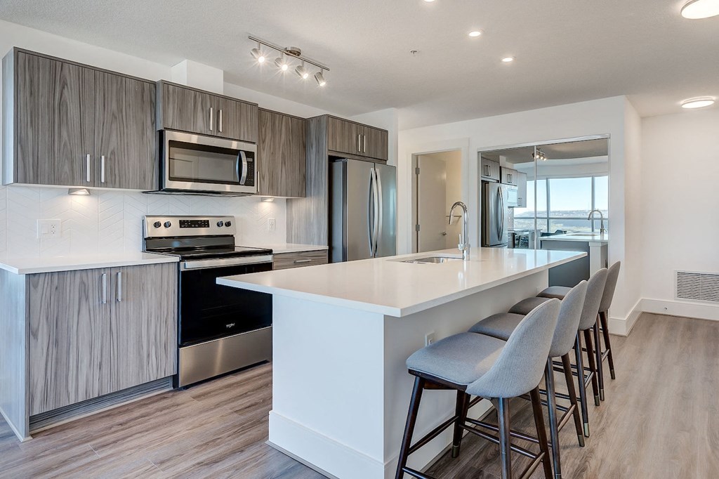 a kitchen with a large white counter top and