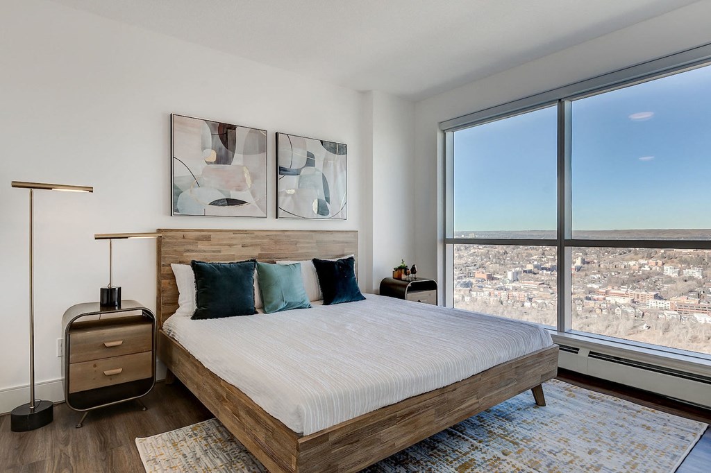 a bedroom with a bed and a large window