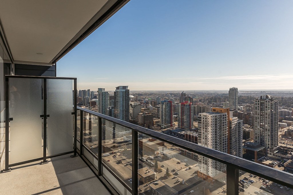 a view of the city from the balcony of a condo