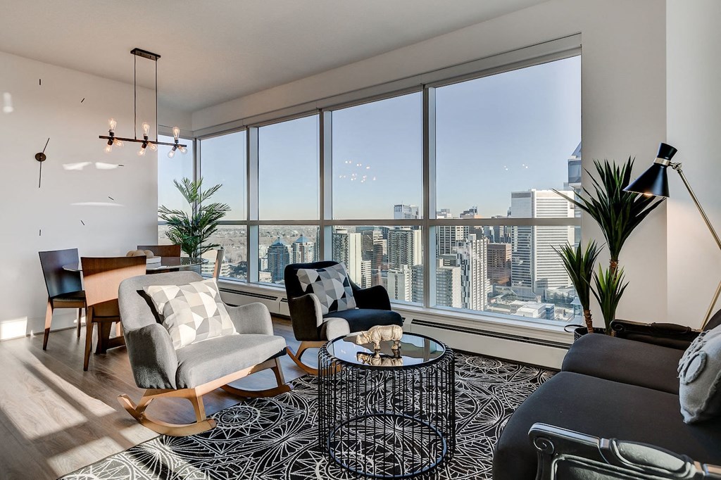 a living room with a view of the city and a large window