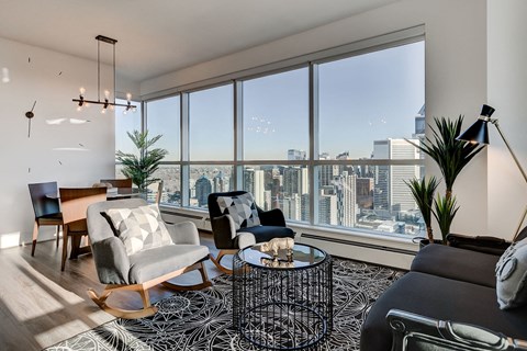 a living room with a view of the city and a large window
