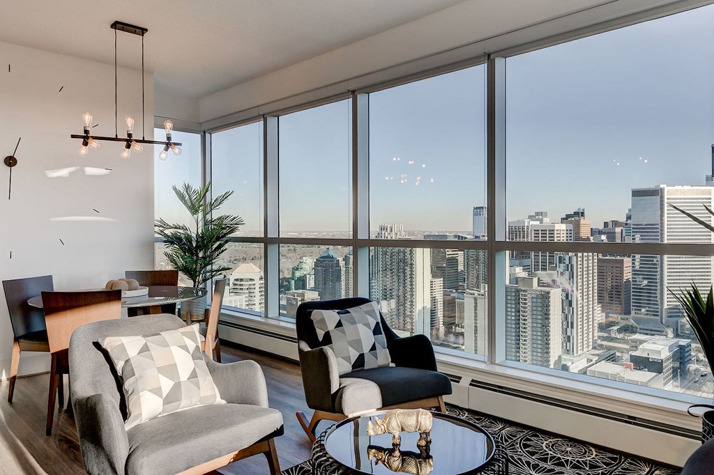 a living room with a view of the city and a large window