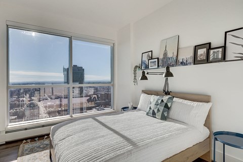 a bedroom with a bed and a large window