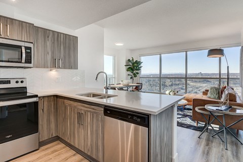 an open kitchen and living room with a view of the city