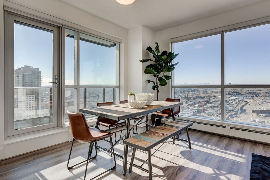 a dining room with a view of the city and a table and chairs