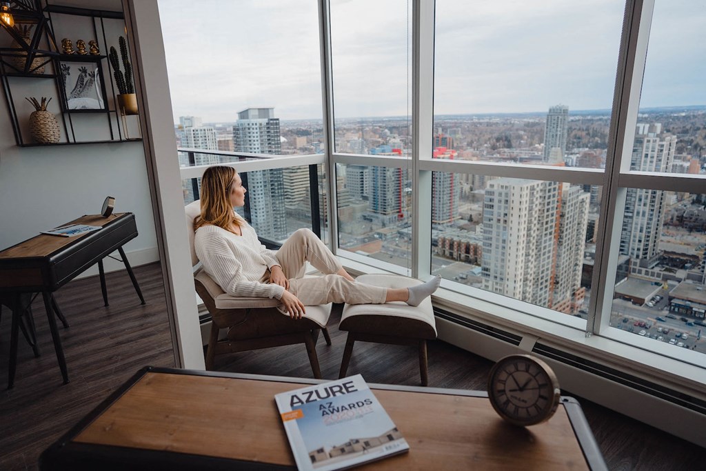 a woman sitting on a chair in a window