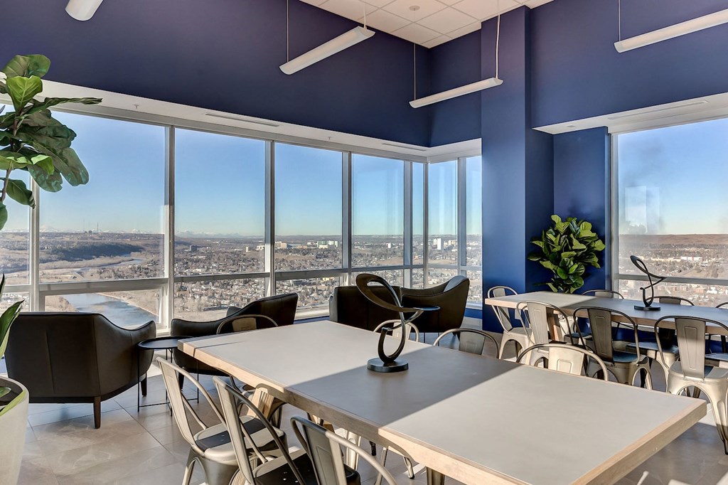 a conference room with tables and chairs and a view of the city