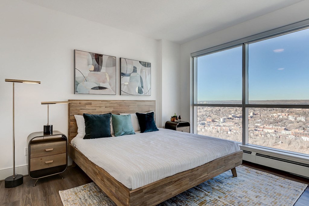 a bedroom with a bed and a large window