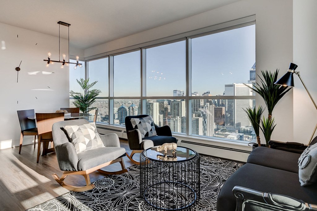 a living room with a view of the city and a large window
