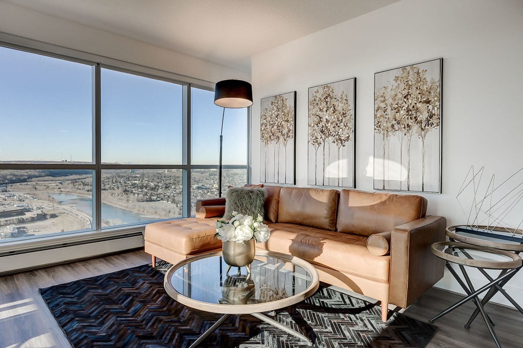 a living room with a couch and a table and a view of the city