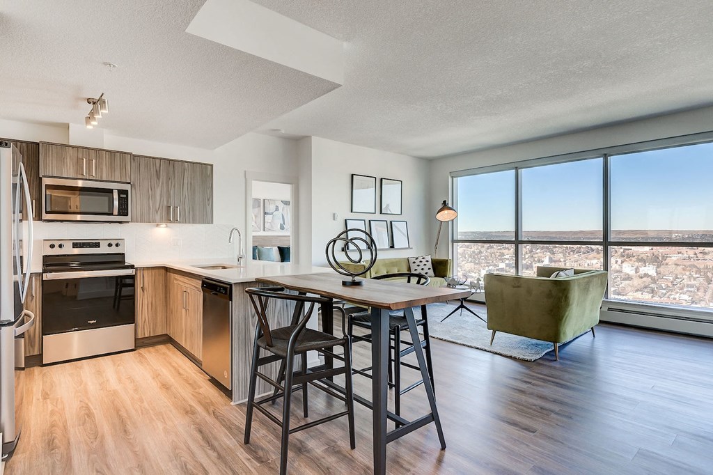 an open kitchen and living room with a view of the city