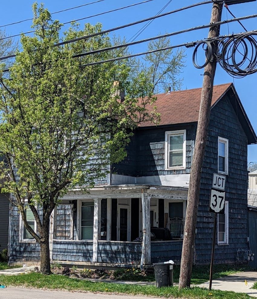 a blue house with a street sign in front of it