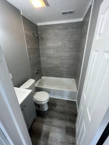 A bathroom with a toilet, sink, and bathtub.