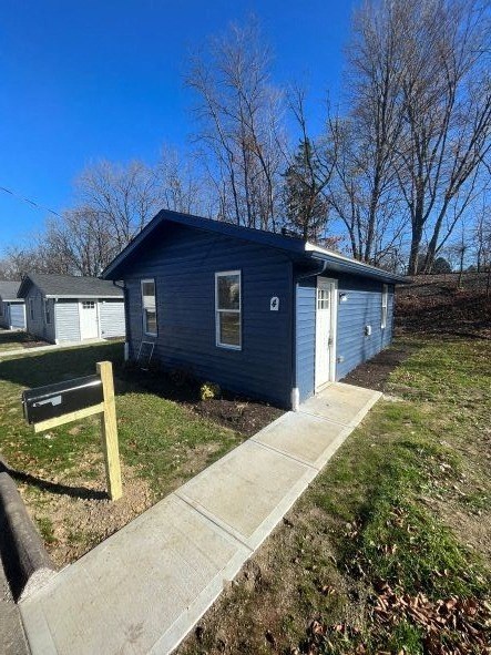 A blue house with a mailbox in front.