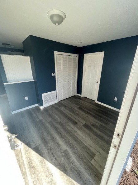 A room with dark blue walls and wooden flooring.