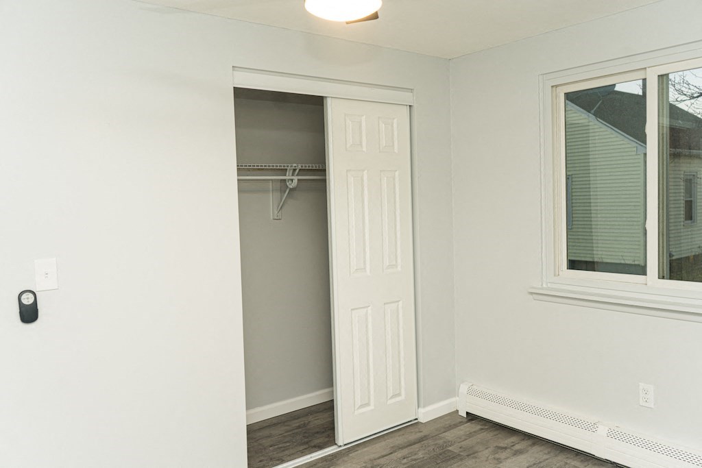a closet in a room with a window and a white door