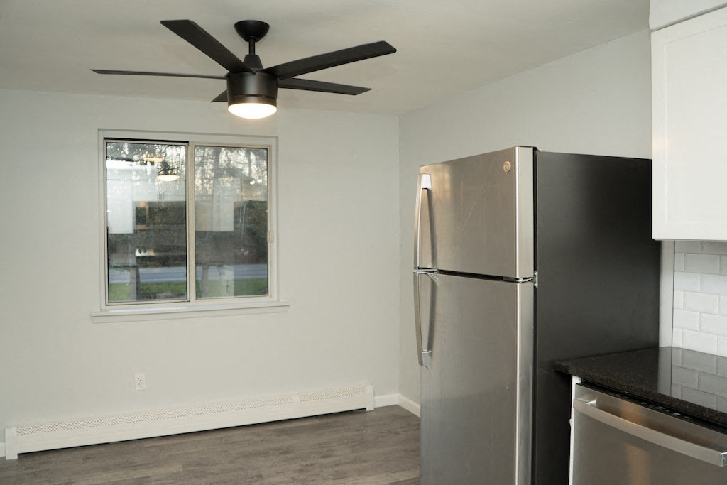 a kitchen with a stainless steel refrigerator and a ceiling fan
