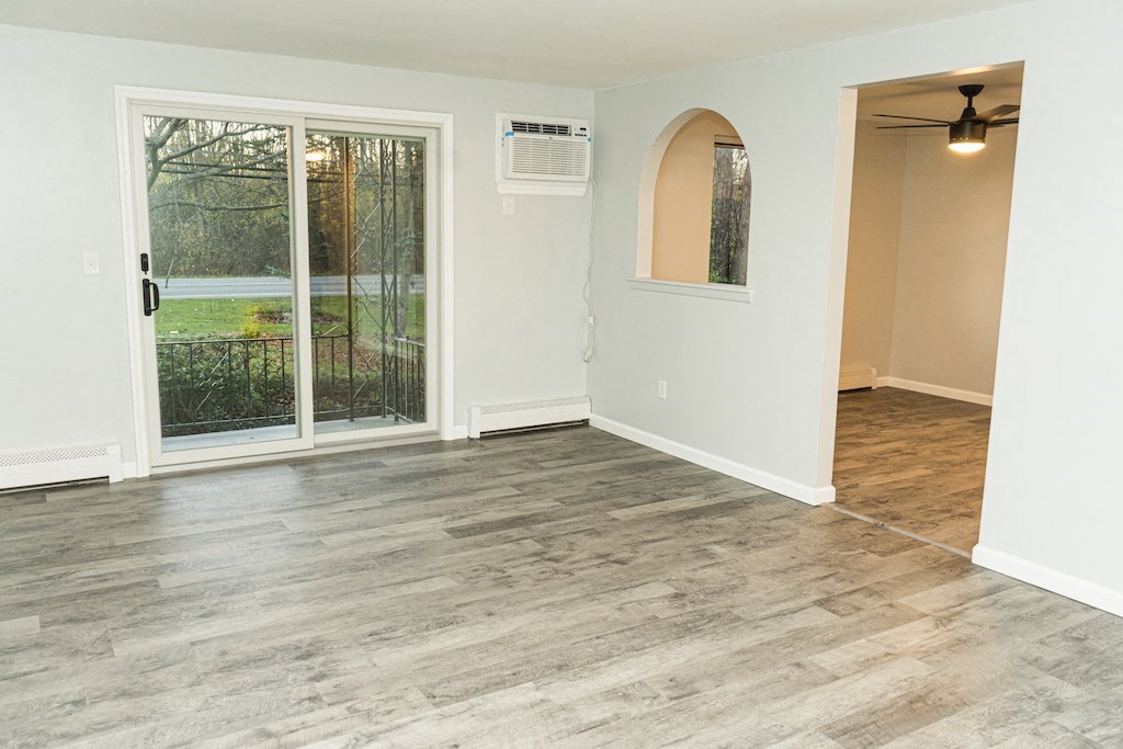 an empty living room with a sliding glass door