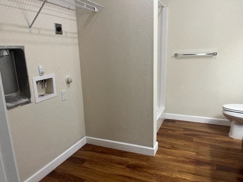 A bathroom with a toilet and a shower.