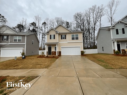 a two story house with a garage and a driveway