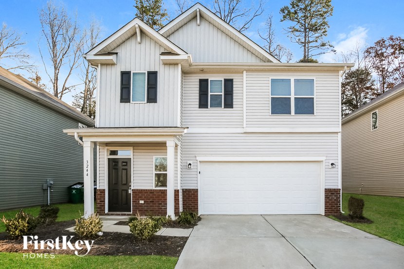 A house with a garage and a driveway in front.