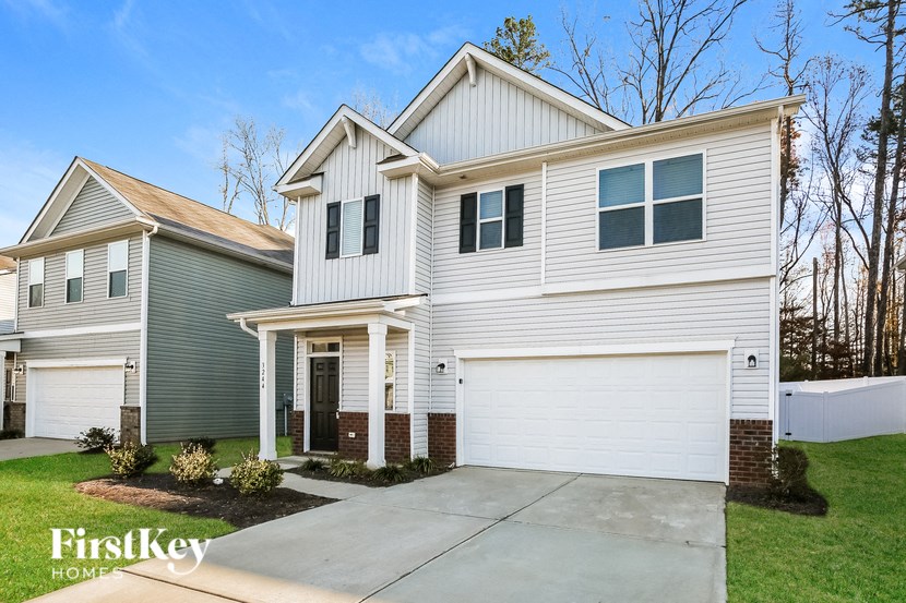 A white house with a garage is shown in the image.