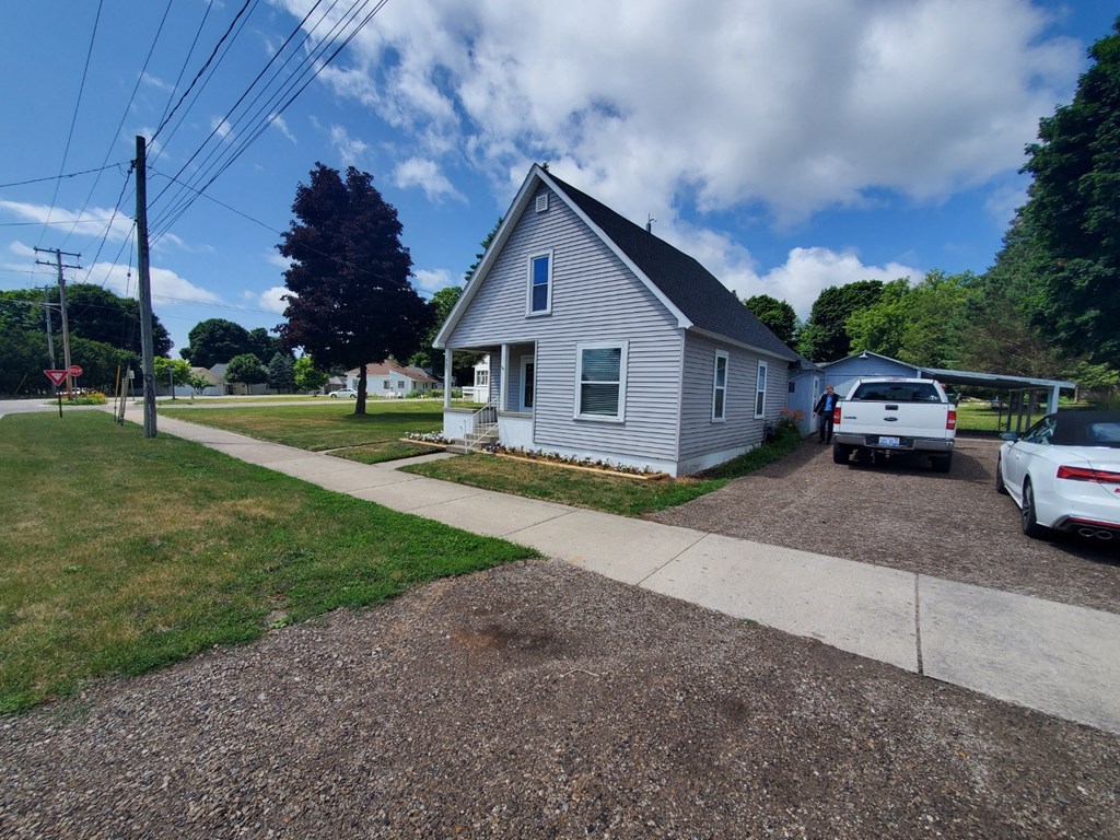 a blue house with a white truck parked outside