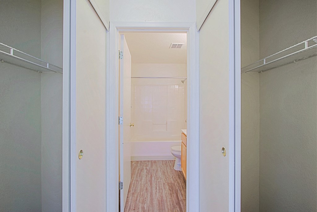 an empty room with a door open to a bathroom
