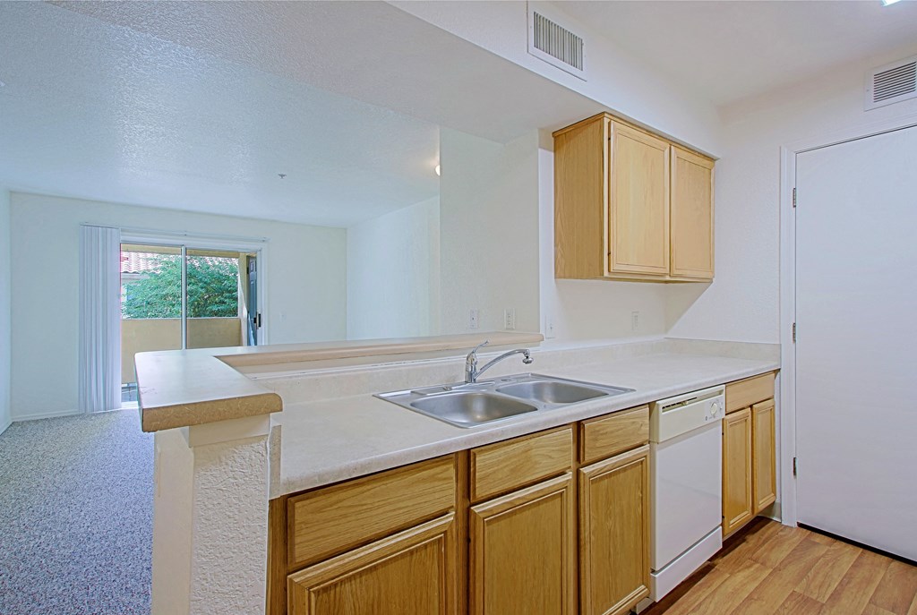 a kitchen with a sink and wooden cabinets