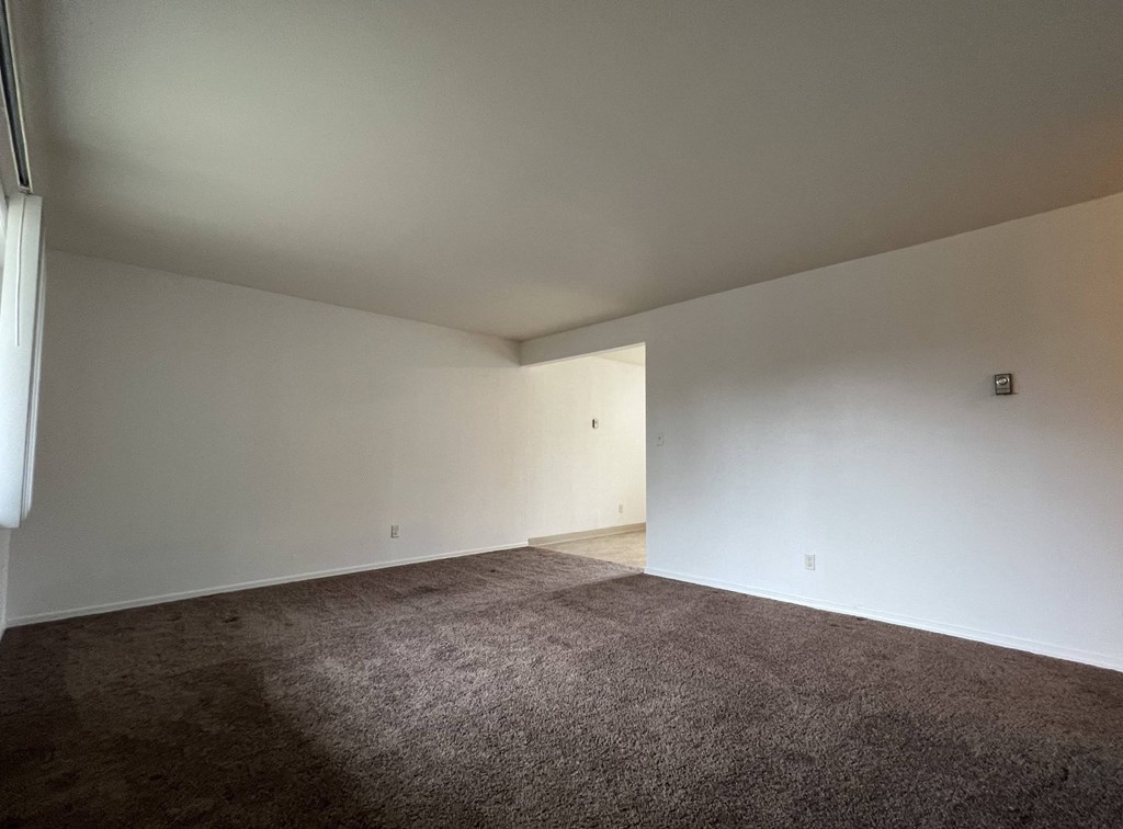 a empty room with carpet and white walls