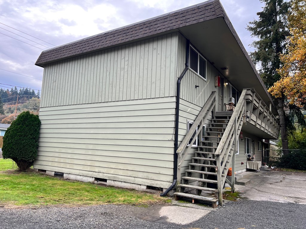 the side of a church building with stairs and a porch
