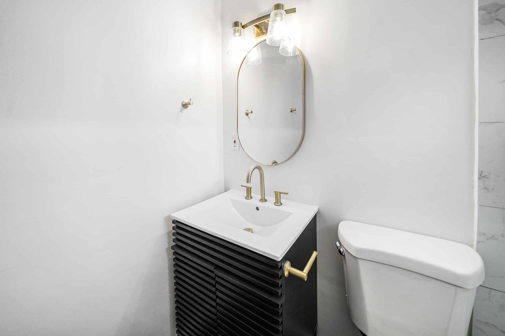 a small bathroom with a sink and a toilet and a mirror