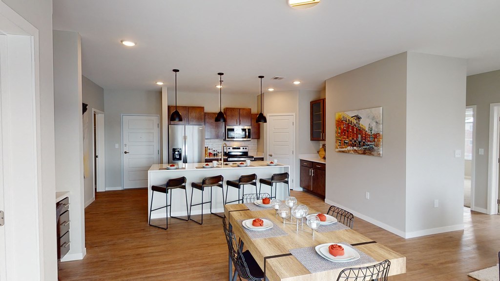 a kitchen and dining room with a table and chairs