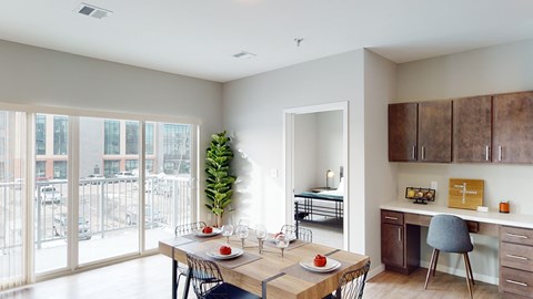 a dining room with a table and chairs and a balcony