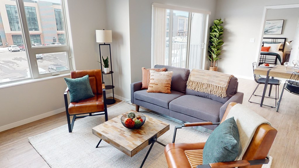 a living room with a couch and chairs and a table