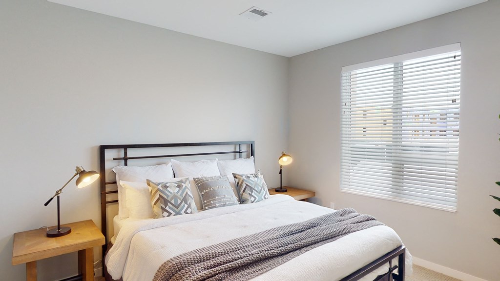 a bedroom with a large bed and a window