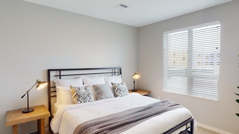 a bedroom with a large bed and a window