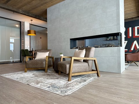 a living room with two chairs and a fireplace