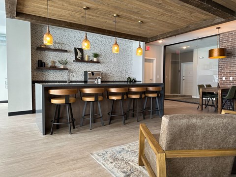 a bar area in a living room with bar stools