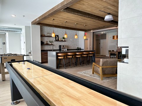 a kitchen and living room with a bar and a pool table