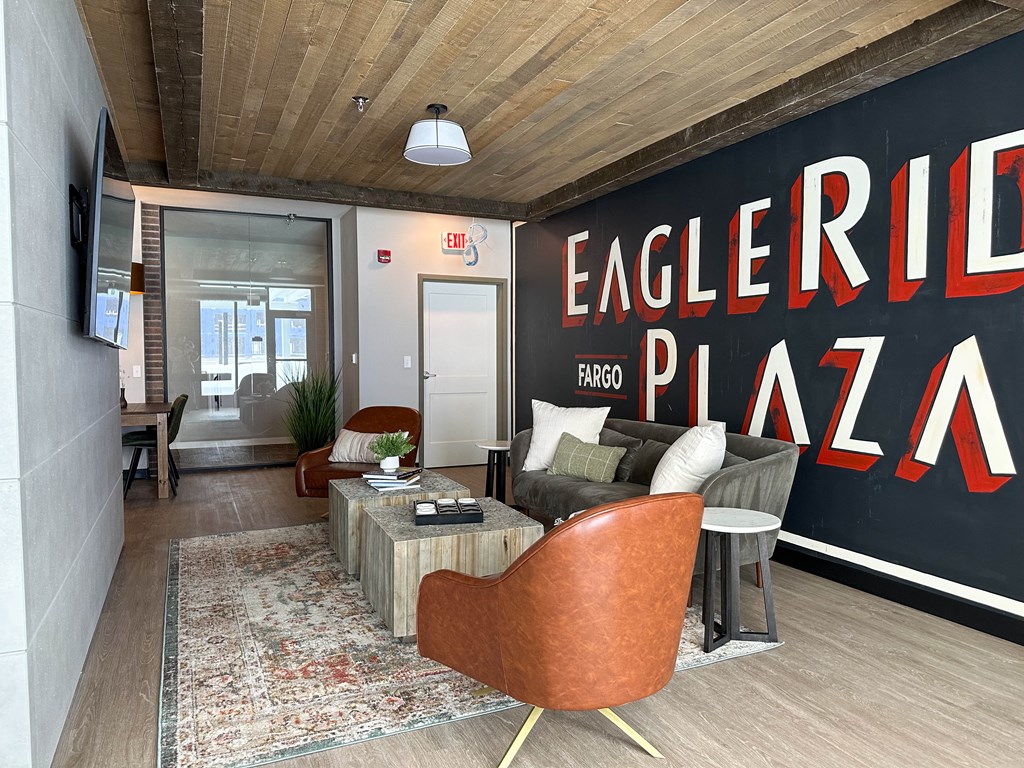 a living room with a large mural on the wall