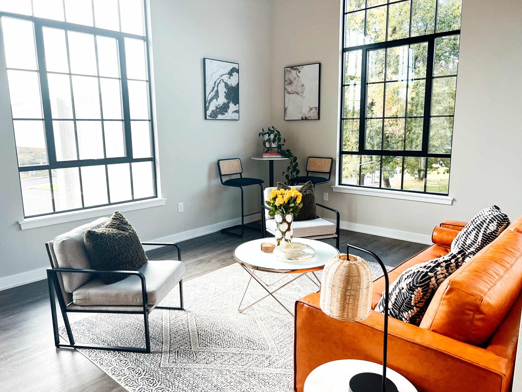 a living room with a couch and chairs and a table