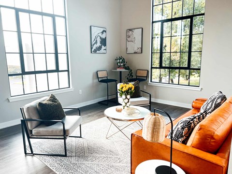a living room with a couch and chairs and a table