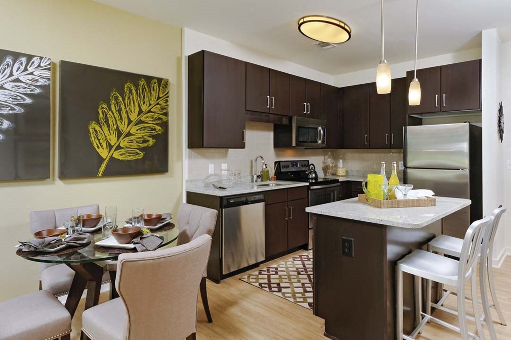a kitchen and dining room with a table and chairs