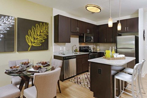 a kitchen and dining room with a table and chairs