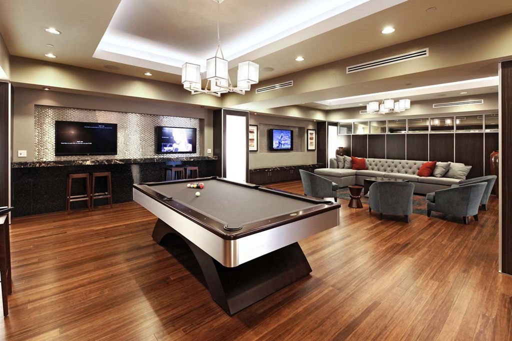 a game room with a pool table and a tv