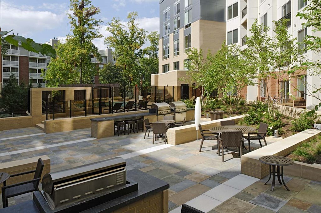 a rendering of a courtyard with tables and benches