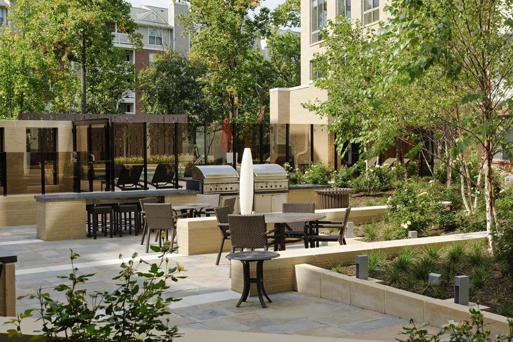 a courtyard with tables and chairs and a fountain