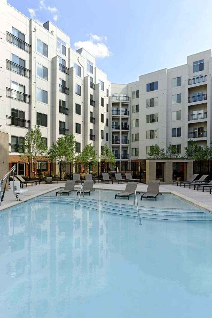 a swimming pool in front of an apartment building